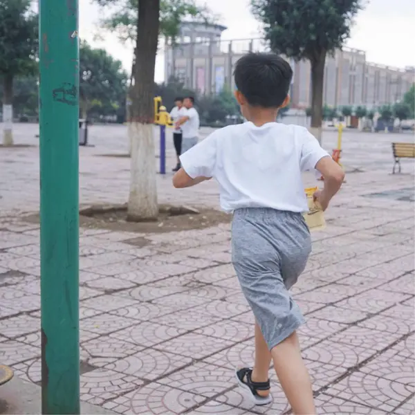 stock image asian boy playing with his skateboard