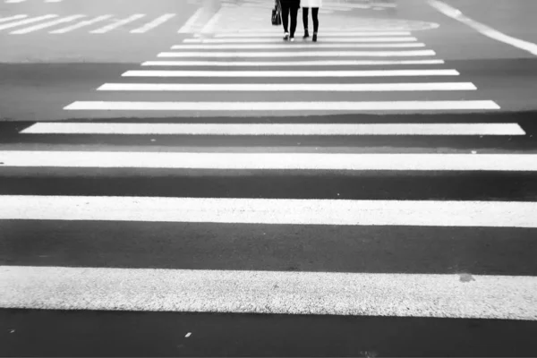 pedestrian crossing the road in the city