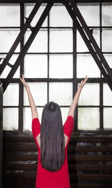 Rear View Woman Standing Arms Raised Window — Stock Photo, Image