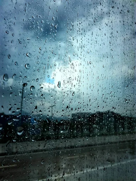 rain drops on glass, wet window and rainy weather