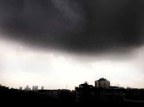 silhouette of a city with a stormy sky