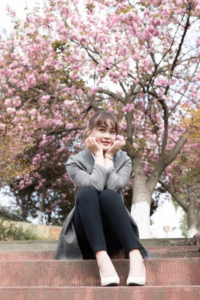 cute asian woman in Cherry Blossom garden alone