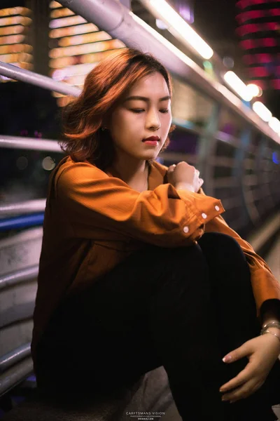 Young asian woman at night city