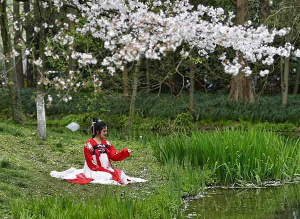 young asian woman in Cherry Blossom garden