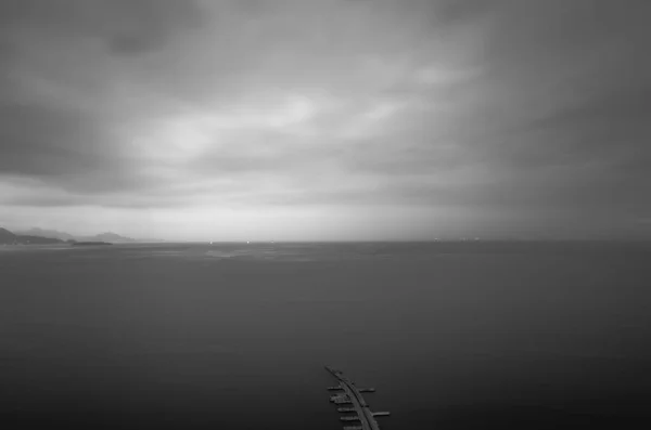 black and white clouds over the sea