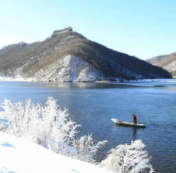 man on the lake in the mountains