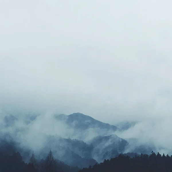 mountain landscape with fog and clouds