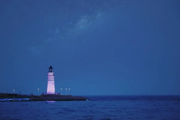 lighthouse in the night sky