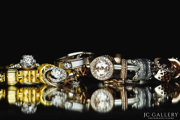 jewelry and diamond ring on black background