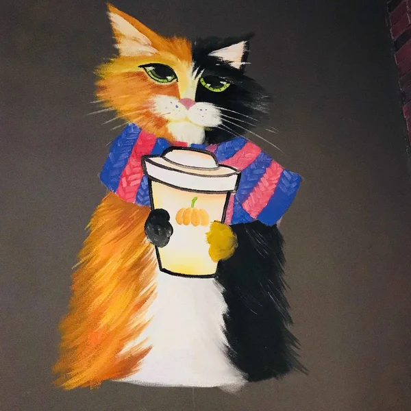 cat with a red scarf and a cup of coffee on a background of a colored paper