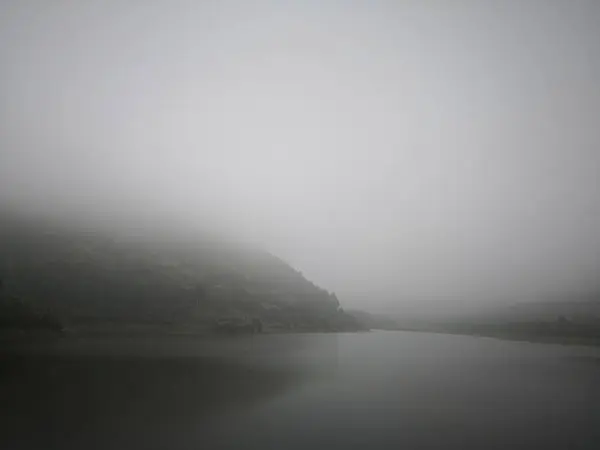 black foggy lake in the fog