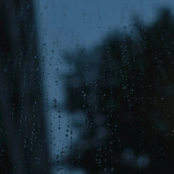 glass window with rain drops, rainy weather