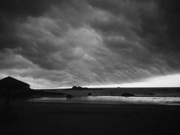 black and white clouds over the ocean
