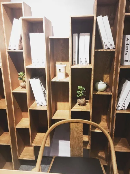 wooden shelf with different objects on shelves in modern interior