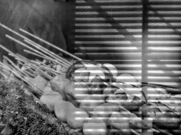 close up of a row of black and white of a hammock in the park