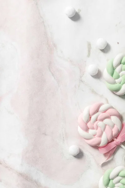 white and pink marshmallows on a gray background