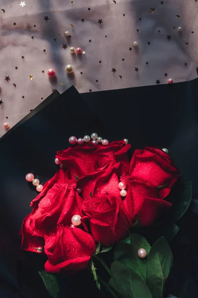 red roses in a box with a rose