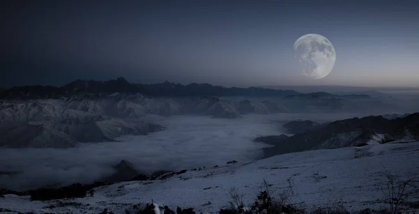 beautiful landscape with a moon and a mountain in the background