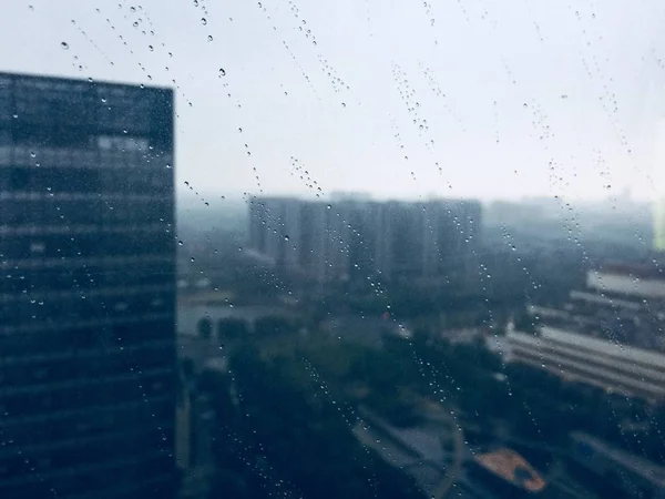 rain drops on glass, wet window and rainy weather