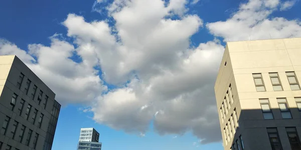 modern building with clouds in the sky