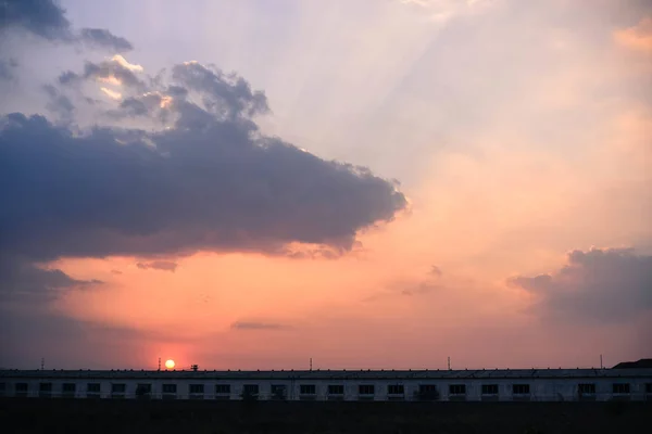 sunset over the city of the town of the sun