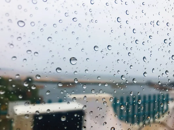 rain drops on glass, wet window and rainy weather