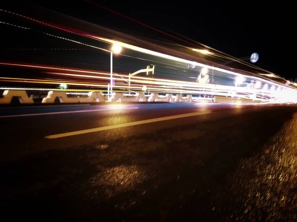 traffic light trails on the road in city at night