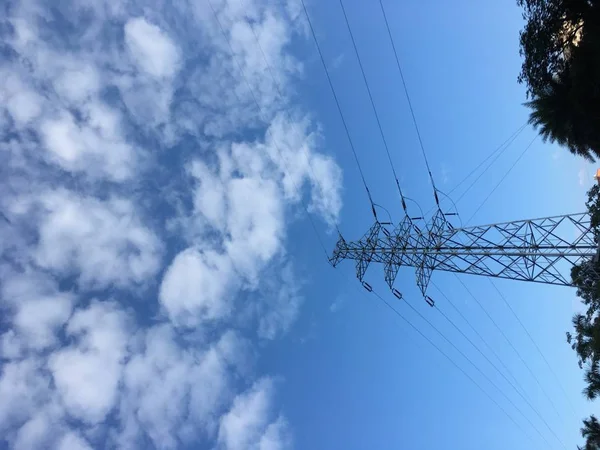 high voltage power lines on blue sky