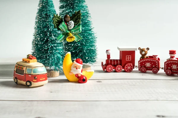 christmas decoration with toy car and toys on wooden background