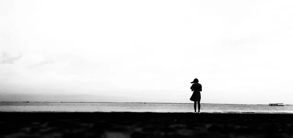 silhouette of a young woman running on the beach at sunset