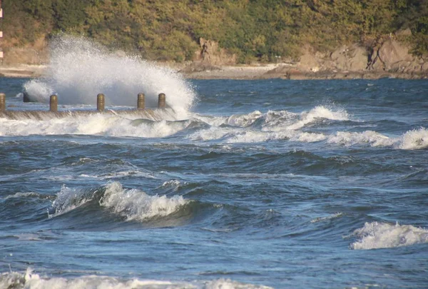 a beautiful view of a small waterfall in the sea