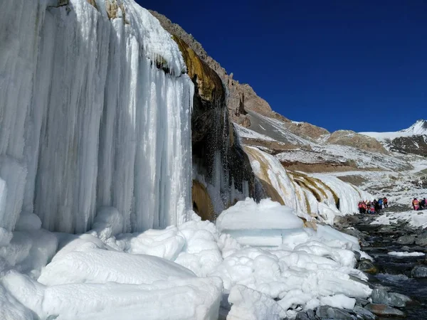 frozen waterfall in winter at day time