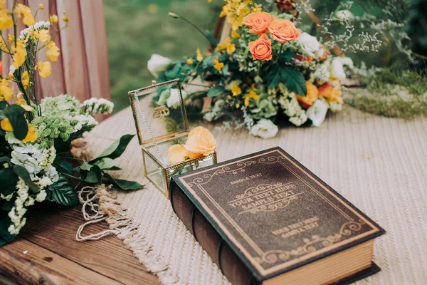 bouquet of flowers and a book on a wooden table