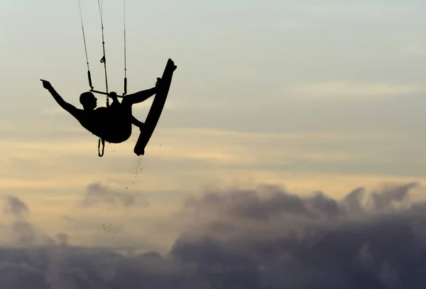 silhouette of man jumping on the cliff