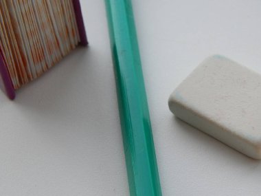 Composition of a small book with a pencil