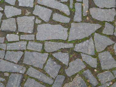 Paving of the street from broken granite stone
