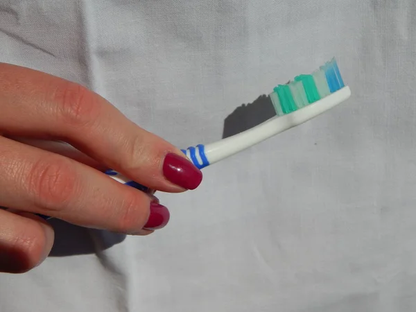 Toothbrush in the hands of a doctor — Stock Photo, Image