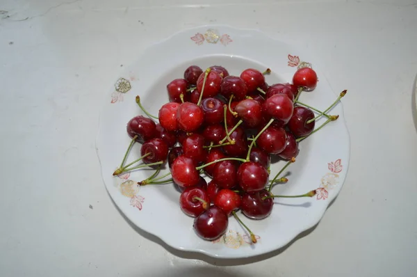 Red cherry closeup on a plate — Stock Photo, Image
