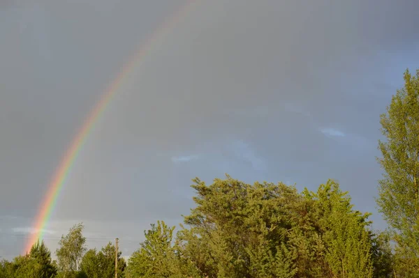 Rainbow over the village after a thunderstorm and the rain