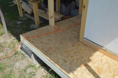 Raflardan ve kirişlerden oluşan verandanın girişinin inşaatı