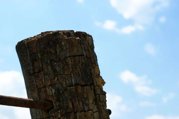 Wooden old brown crossroad sign on a blue sky with clouds — Stock Photo, Image