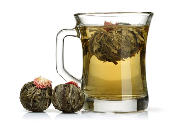 Jasmine tea in glass mug with Jasmine balls isolated on white background