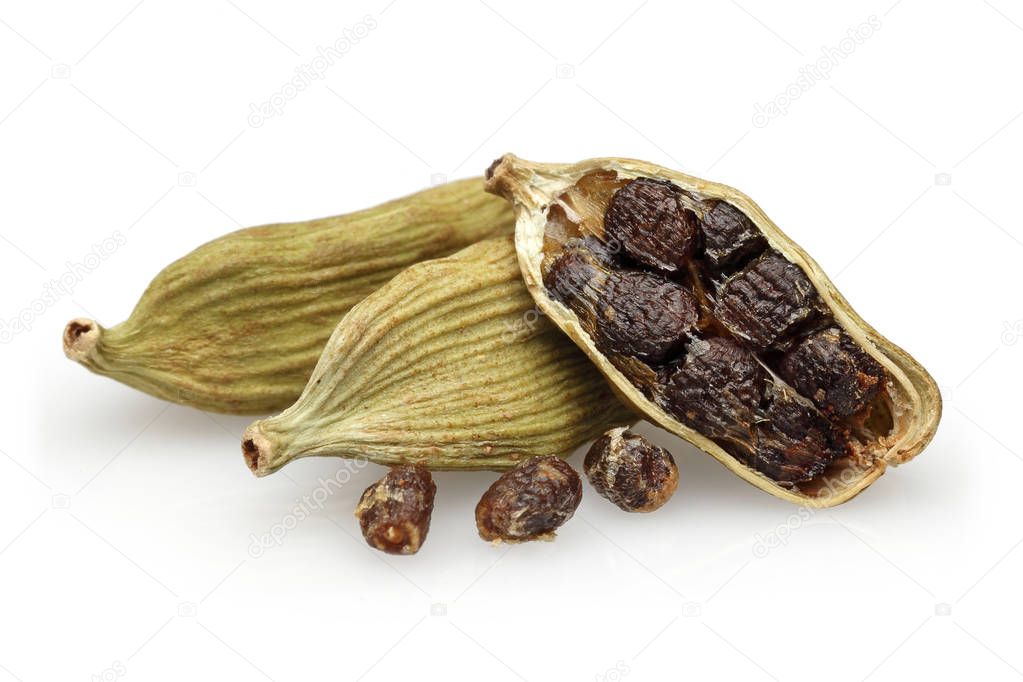 Dry cardamom pods and seeds isolated on white background