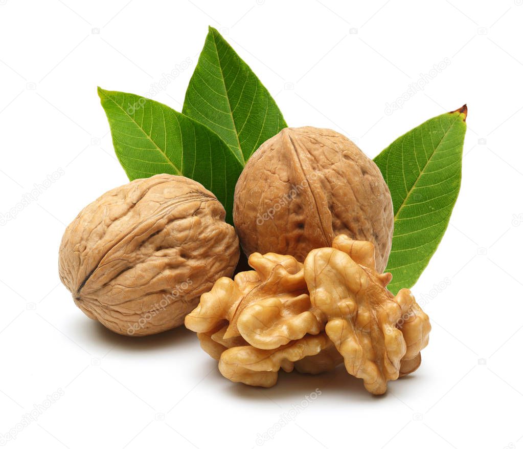 Walnuts and cracked walnut with leaves, isolated on white background