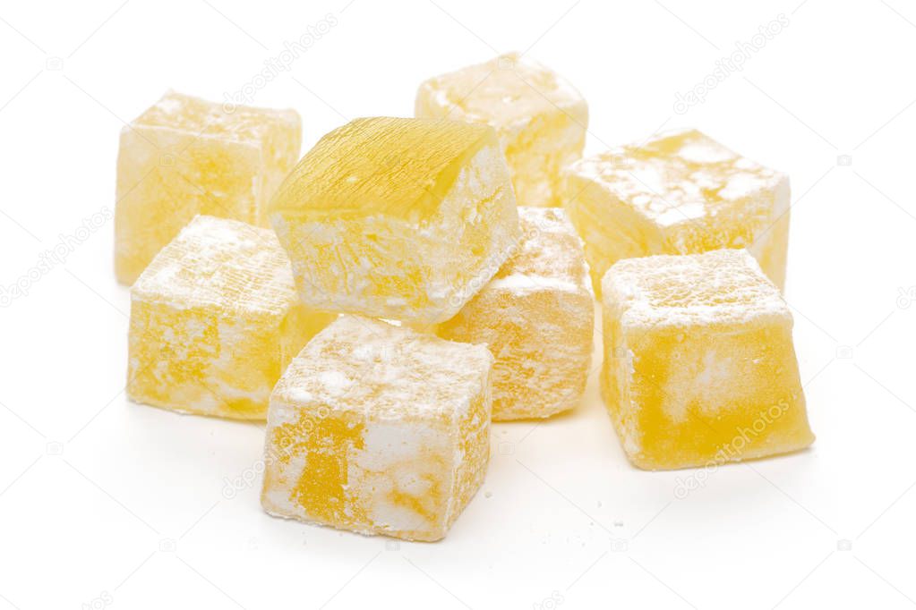 Yellow Turkish delights isolated on white background