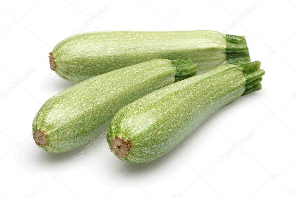 Three whole green zucchini isolated on white background