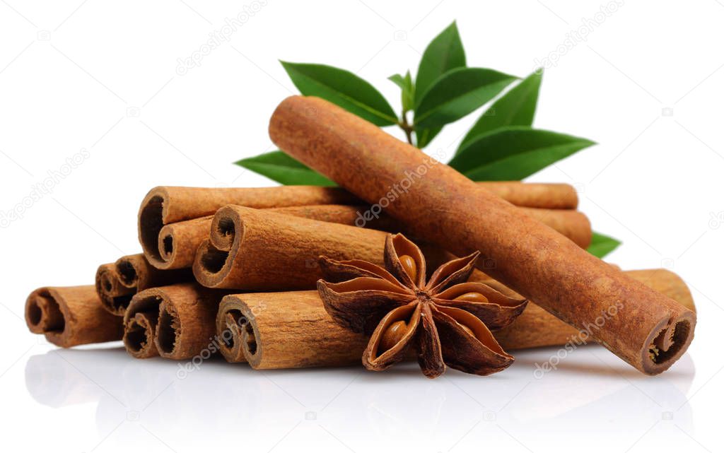 Cinnamon sticks with star anise and green leaves