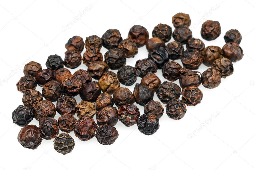 Heap of black peppercorn isolated on white