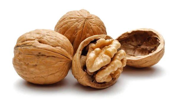 Whole and cracked walnuts isolated on white — Stock Photo, Image