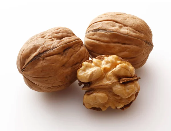 Whole and broken walnuts isolated on white — Stock Photo, Image